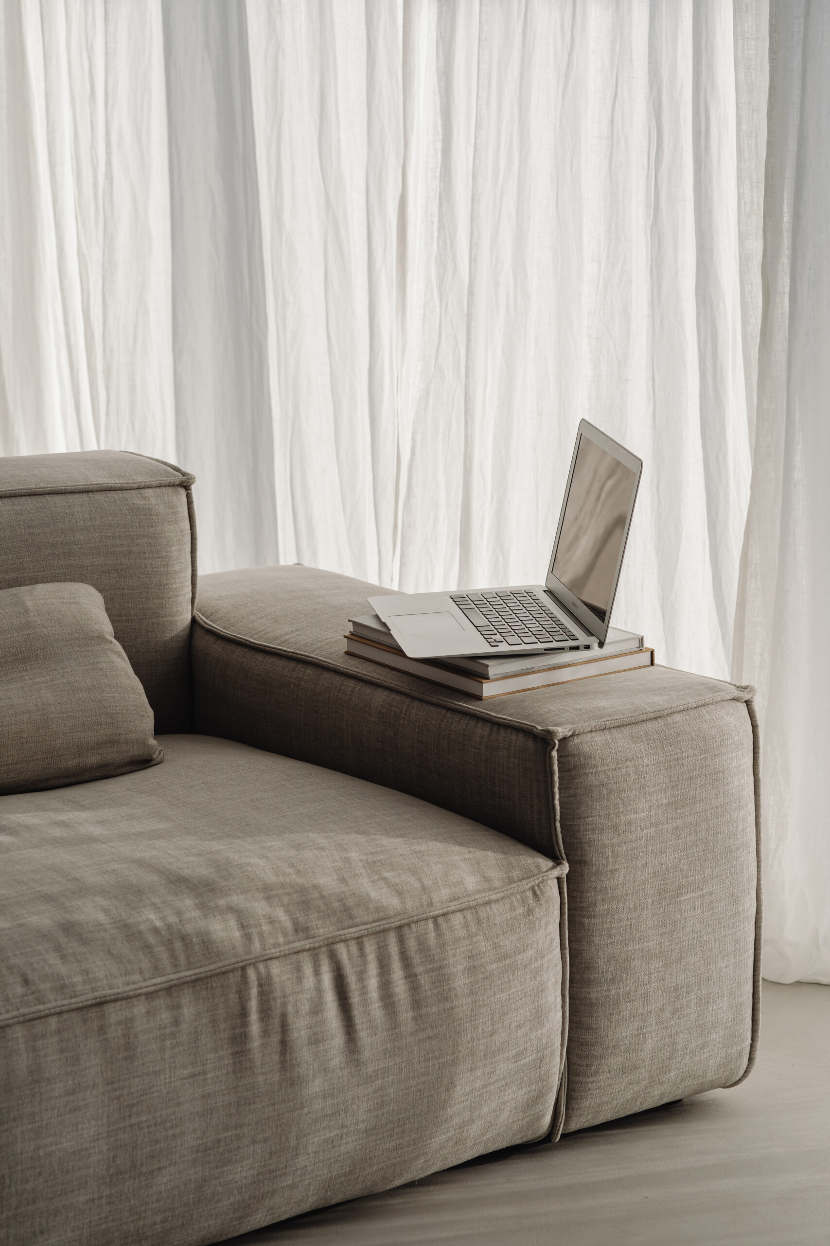 studio pure home office on the sofa books laptop macbook